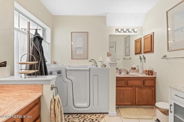 1275 Pirates Cove Ln, Fleming Island, FL 32003 - bathroom featuring two vanities, tile patterned floors, and a garden tub