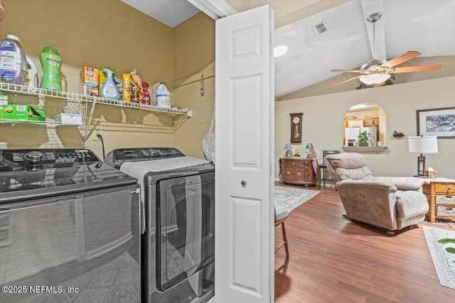 1275 Pirates Cove Ln, Fleming Island, FL 32003 - washroom featuring separate washer and dryer, a ceiling fan, wood finished floors, and arched walkways