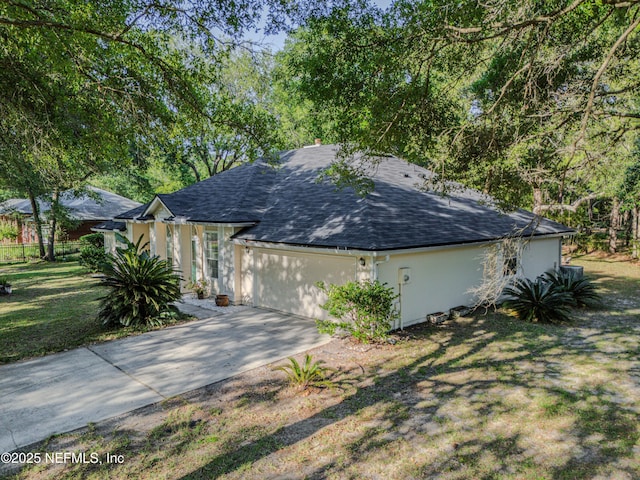 96428 Chester Rd, Yulee, FL 32097 - single story home with a shingled roof, an attached garage, concrete driveway, and stucco siding