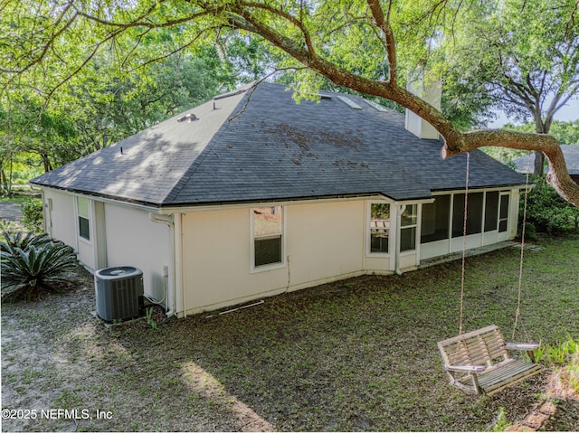 96428 Chester Rd, Yulee, FL 32097 - rear view of house with a shingled roof, central AC, and a sunroom