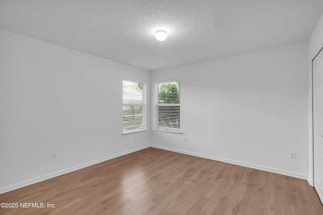 96428 Chester Rd, Yulee, FL 32097 - unfurnished room featuring a textured ceiling, light wood finished floors, and baseboards