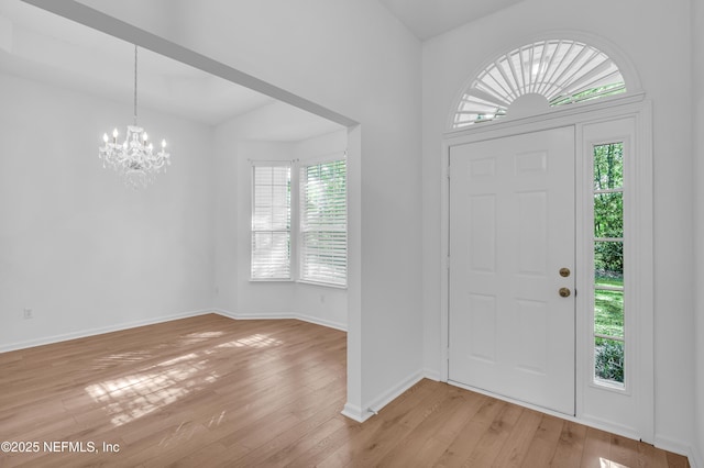 96428 Chester Rd, Yulee, FL 32097 - entrance foyer with a chandelier, light wood-style floors, and baseboards