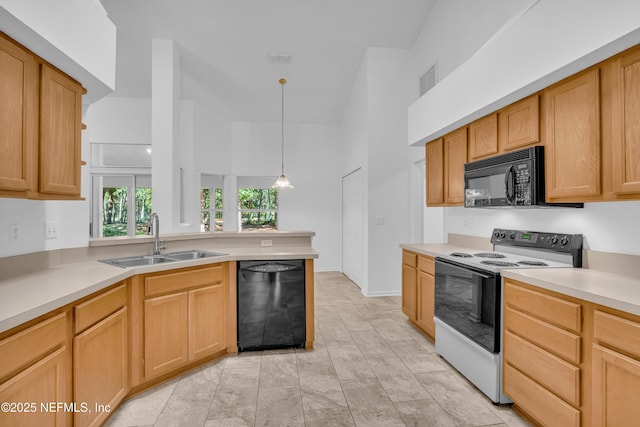 96428 Chester Rd, Yulee, FL 32097 - kitchen with black appliances, a sink, a peninsula, light countertops, and decorative light fixtures