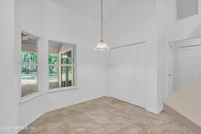 96428 Chester Rd, Yulee, FL 32097 - unfurnished dining area with a towering ceiling, baseboards, and a ceiling fan