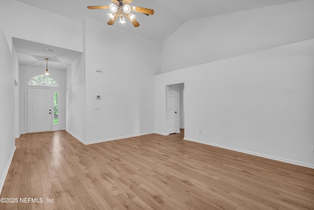 96428 Chester Rd, Yulee, FL 32097 - unfurnished living room featuring high vaulted ceiling, ceiling fan, light wood-type flooring, and baseboards