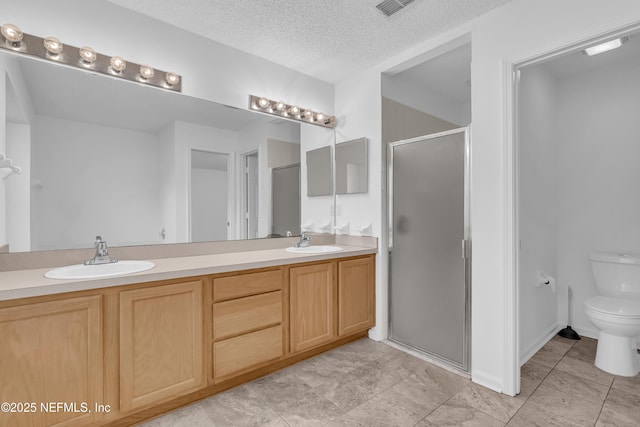 96428 Chester Rd, Yulee, FL 32097 - full bath with double vanity, a stall shower, toilet, and a textured ceiling