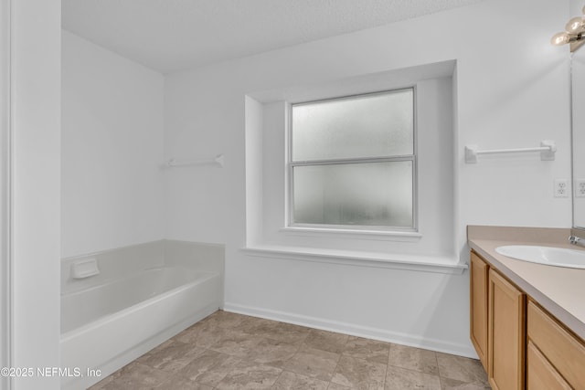 96428 Chester Rd, Yulee, FL 32097 - bathroom with vanity, a bathtub, and baseboards