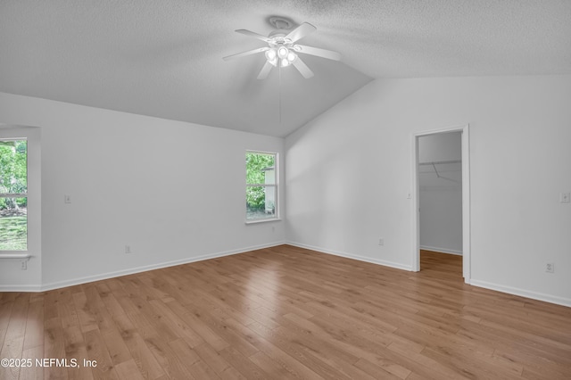 96428 Chester Rd, Yulee, FL 32097 - unfurnished room with ceiling fan, vaulted ceiling, light wood-type flooring, a textured ceiling, and plenty of natural light