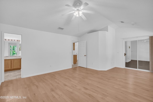 96428 Chester Rd, Yulee, FL 32097 - spare room featuring lofted ceiling, light wood-style flooring, ceiling fan, and a textured ceiling