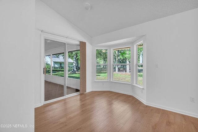96428 Chester Rd, Yulee, FL 32097 - empty room featuring lofted ceiling, wood finished floors, and baseboards