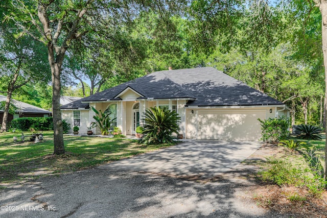 96428 Chester Rd, Yulee, FL 32097 - single story home with driveway, a garage, a shingled roof, and a front lawn