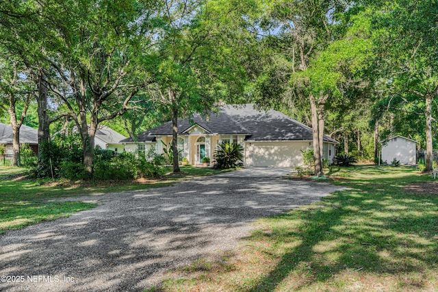 96428 Chester Rd, Yulee, FL 32097 - view of front of home featuring driveway, a garage, roof with shingles, and a front lawn