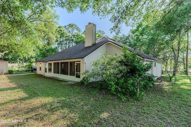 96428 Chester Rd, Yulee, FL 32097 - rear view of property with a chimney, a yard, a sunroom, and a shingled roof