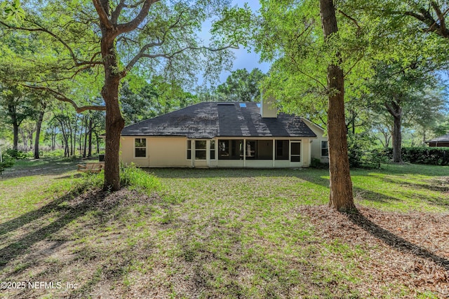 96428 Chester Rd, Yulee, FL 32097 - back of property with a sunroom, a yard, and a chimney
