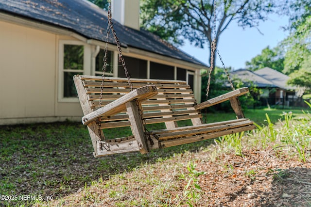 96428 Chester Rd, Yulee, FL 32097 - back of house featuring a sunroom, a chimney, and roof with shingles