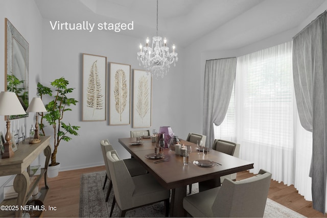 96428 Chester Rd, Yulee, FL 32097 - dining area featuring light wood-type flooring, a chandelier, lofted ceiling, and baseboards