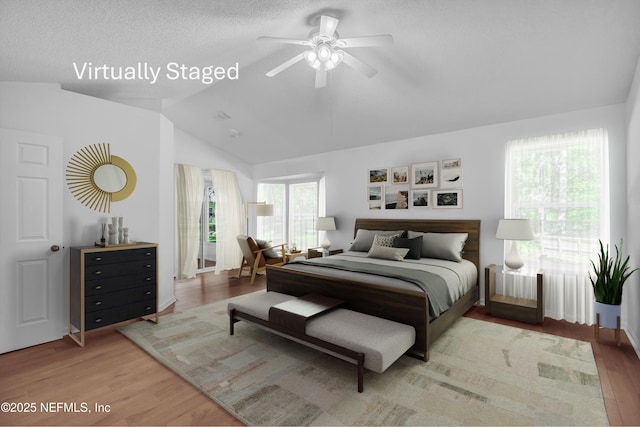 96428 Chester Rd, Yulee, FL 32097 - bedroom featuring lofted ceiling, wood finished floors, and a textured ceiling