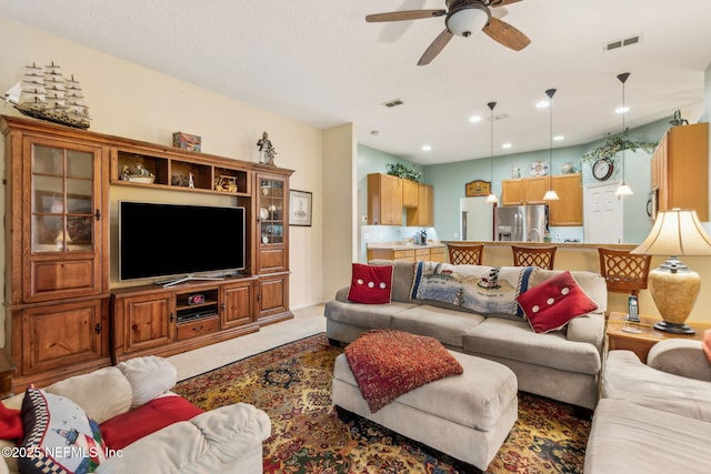 living room featuring ceiling fan, light carpet, and recessed lighting