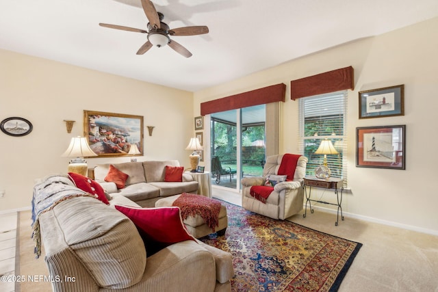 carpeted living room featuring ceiling fan and baseboards