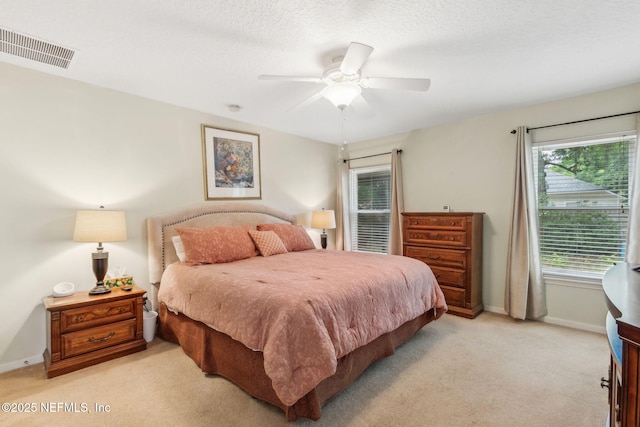 bedroom featuring light carpet, baseboards, and ceiling fan