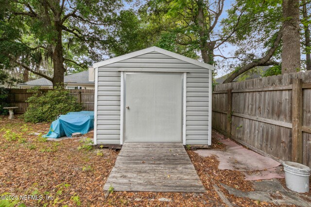view of shed with a fenced backyard