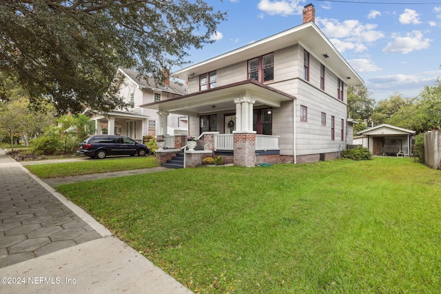 2143 Myra St, Jacksonville, FL 32204 - american foursquare style home with covered porch, a front yard, and a chimney