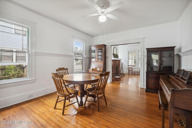 2143 Myra St, Jacksonville, FL 32204 - dining space with a brick fireplace, ceiling fan, wood finished floors, and baseboards