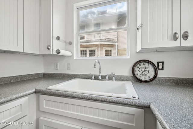 2143 Myra St, Jacksonville, FL 32204 - kitchen with a sink, white cabinets, and dark countertops