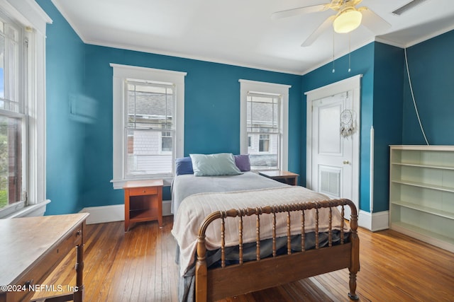 2143 Myra St, Jacksonville, FL 32204 - bedroom featuring baseboards, multiple windows, hardwood / wood-style floors, and ornamental molding