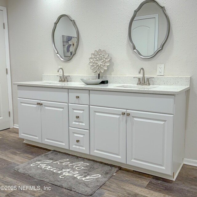 5491 River Trail Rd N, Jacksonville, FL 32277 - full bath with wood finished floors, double vanity, and baseboards