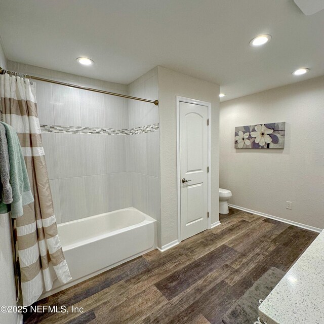 5491 River Trail Rd N, Jacksonville, FL 32277 - bathroom with toilet, wood finished floors, recessed lighting, shower / bath combination with curtain, and baseboards