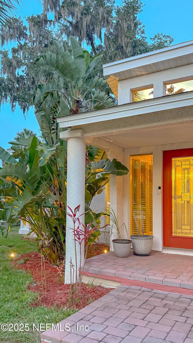 5491 River Trail Rd N, Jacksonville, FL 32277 - doorway to property featuring stucco siding and covered porch