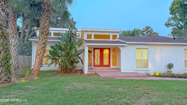5491 River Trail Rd N, Jacksonville, FL 32277 - view of front facade with stucco siding, french doors, and roof with shingles