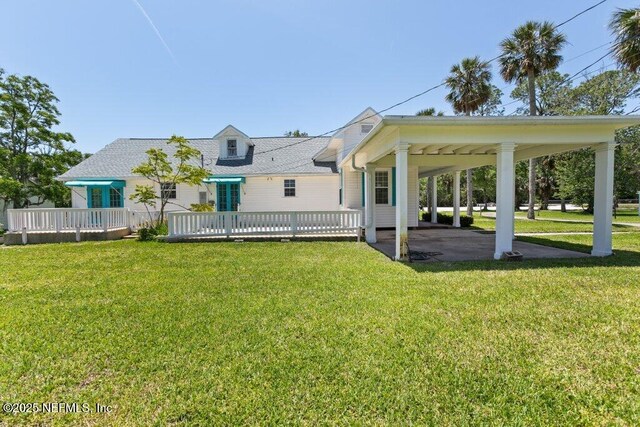 3060 Lewis Speedway, Saint Augustine, FL 32084 - back of house with a lawn, a carport, and a deck