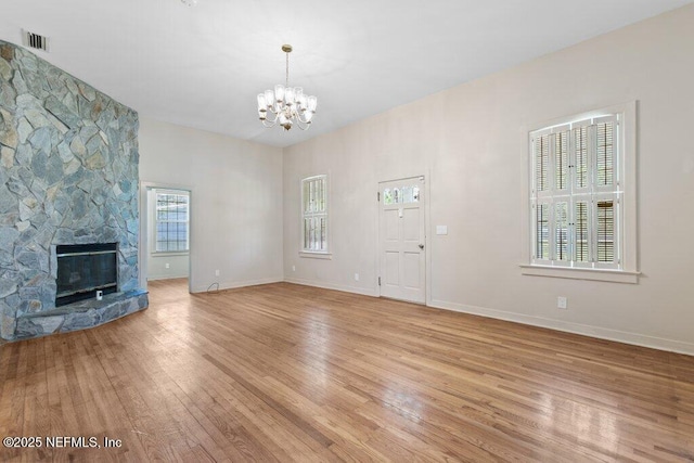 3060 Lewis Speedway, Saint Augustine, FL 32084 - unfurnished living room with light wood-style floors, a chandelier, and baseboards