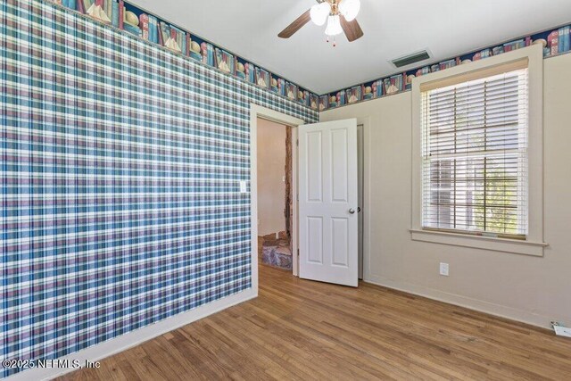 3060 Lewis Speedway, Saint Augustine, FL 32084 - unfurnished bedroom featuring baseboards, wood finished floors, and a ceiling fan