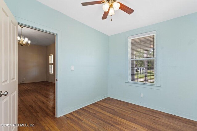 3060 Lewis Speedway, Saint Augustine, FL 32084 - unfurnished room with a chandelier, dark wood finished floors, healthy amount of natural light, and ceiling fan