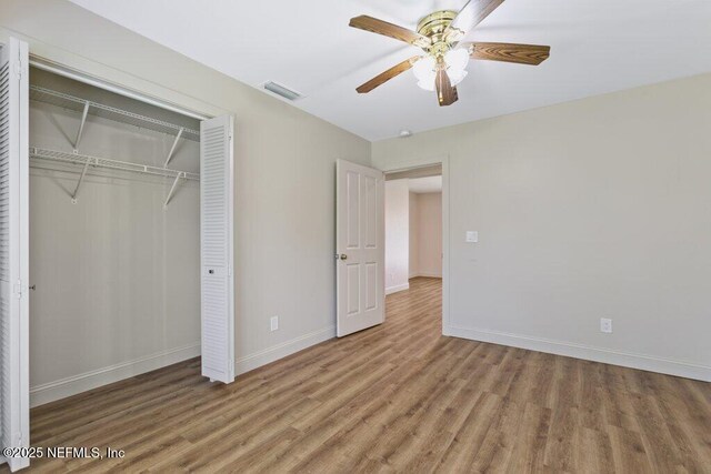 3060 Lewis Speedway, Saint Augustine, FL 32084 - unfurnished bedroom featuring light wood finished floors, a closet, baseboards, and ceiling fan