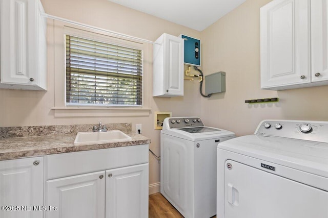 3060 Lewis Speedway, Saint Augustine, FL 32084 - laundry area featuring independent washer and dryer, cabinet space, water heater, and wood finished floors