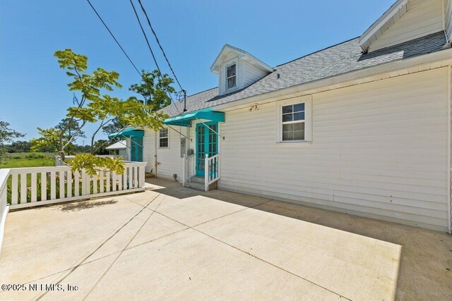 3060 Lewis Speedway, Saint Augustine, FL 32084 - back of property featuring a patio and roof with shingles