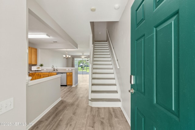 7990 Baymeadows Rd Unit 2404, Jacksonville, FL 32256 - foyer with stairs, light wood finished floors, a chandelier, and baseboards