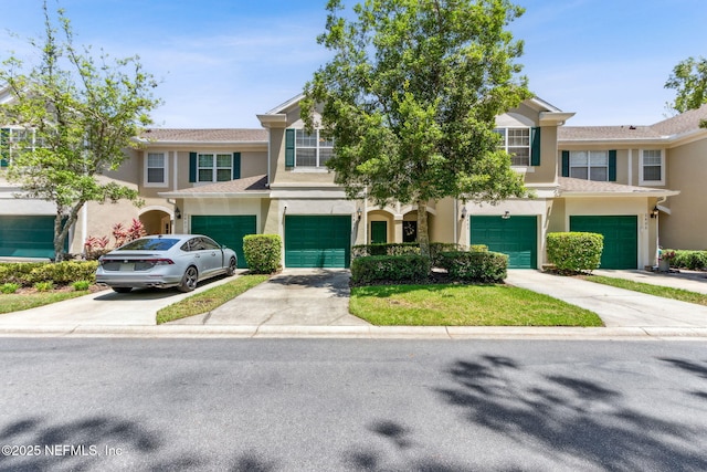 7990 Baymeadows Rd Unit 2404, Jacksonville, FL 32256 - townhome / multi-family property featuring stucco siding, driveway, and an attached garage