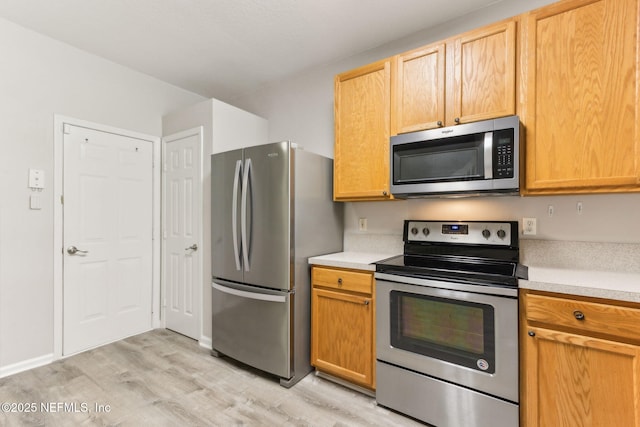 7990 Baymeadows Rd Unit 2404, Jacksonville, FL 32256 - kitchen featuring stainless steel appliances, light wood-style floors, light countertops, and baseboards