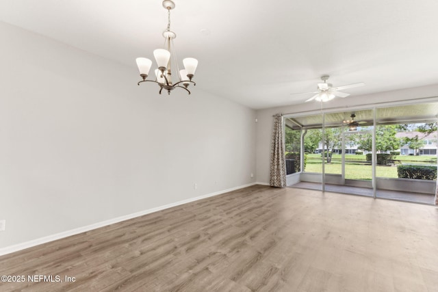 7990 Baymeadows Rd Unit 2404, Jacksonville, FL 32256 - spare room with baseboards, wood finished floors, a ceiling fan, and a chandelier
