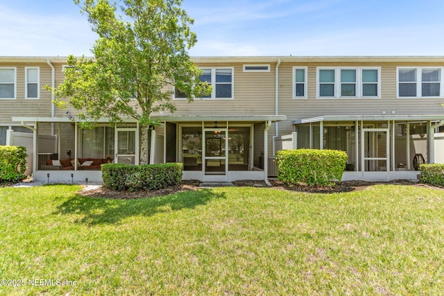7990 Baymeadows Rd Unit 2404, Jacksonville, FL 32256 - rear view of property featuring a sunroom and a lawn