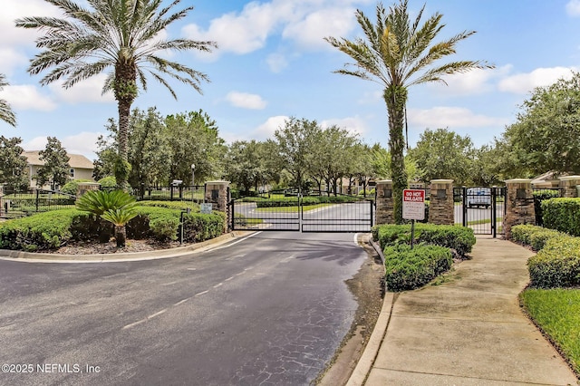7990 Baymeadows Rd Unit 2404, Jacksonville, FL 32256 - view of asphalt street featuring a gate, curbs, and a gated entry