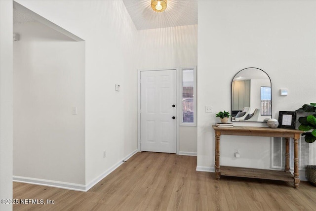 2767 Laten Ln, Jacksonville, FL 32216 - foyer featuring wood finished floors, a towering ceiling, and baseboards