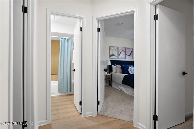 2767 Laten Ln, Jacksonville, FL 32216 - hallway featuring light wood-type flooring and baseboards