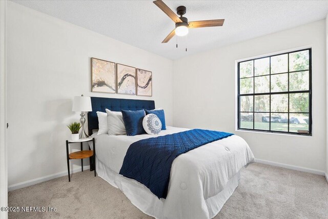 2767 Laten Ln, Jacksonville, FL 32216 - bedroom featuring carpet floors, baseboards, a ceiling fan, and a textured ceiling