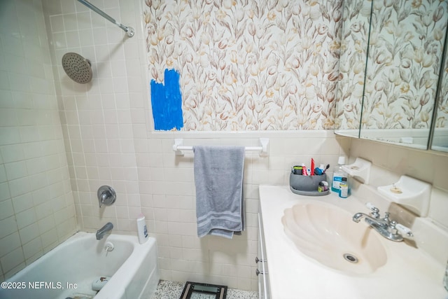 723 Montego Rd W, Jacksonville, FL 32216 - bathroom with tile walls, bathing tub / shower combination, vanity, and a wainscoted wall
